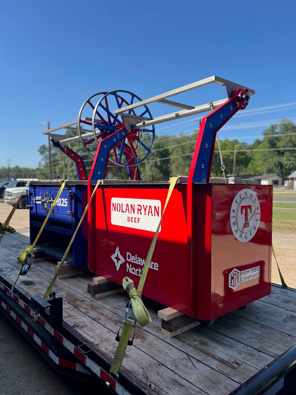 Red El Rey woodfire grill with Texas Rangers and Nolan Ryan Beef branding