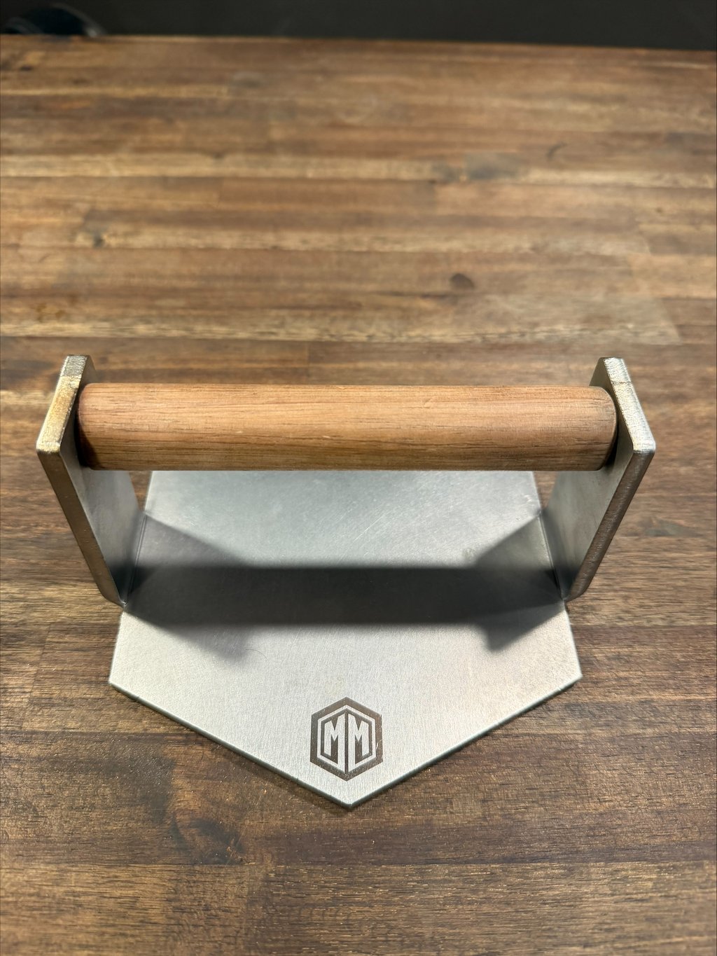 M&M Meat Masher burger press with a walnut handle