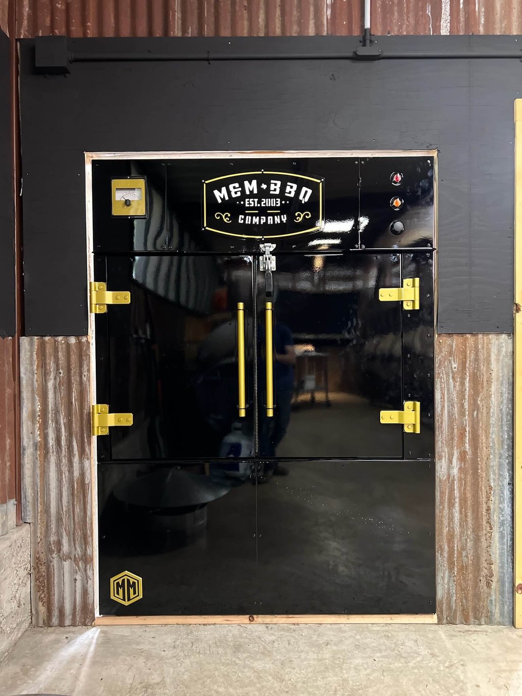 MM1000 rotisserie smoker built into a pit room wall