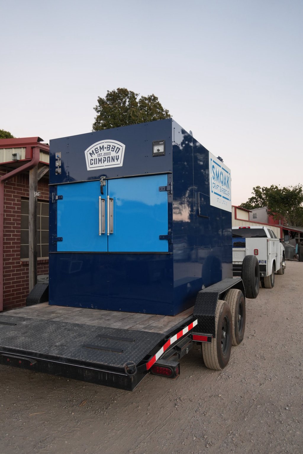 Navy MM2000 rotisserie smoker with light blue doors on a trailer