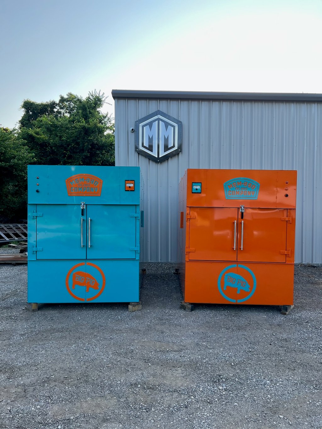 Teal and orange MM2000 rotisserie smokers, front view