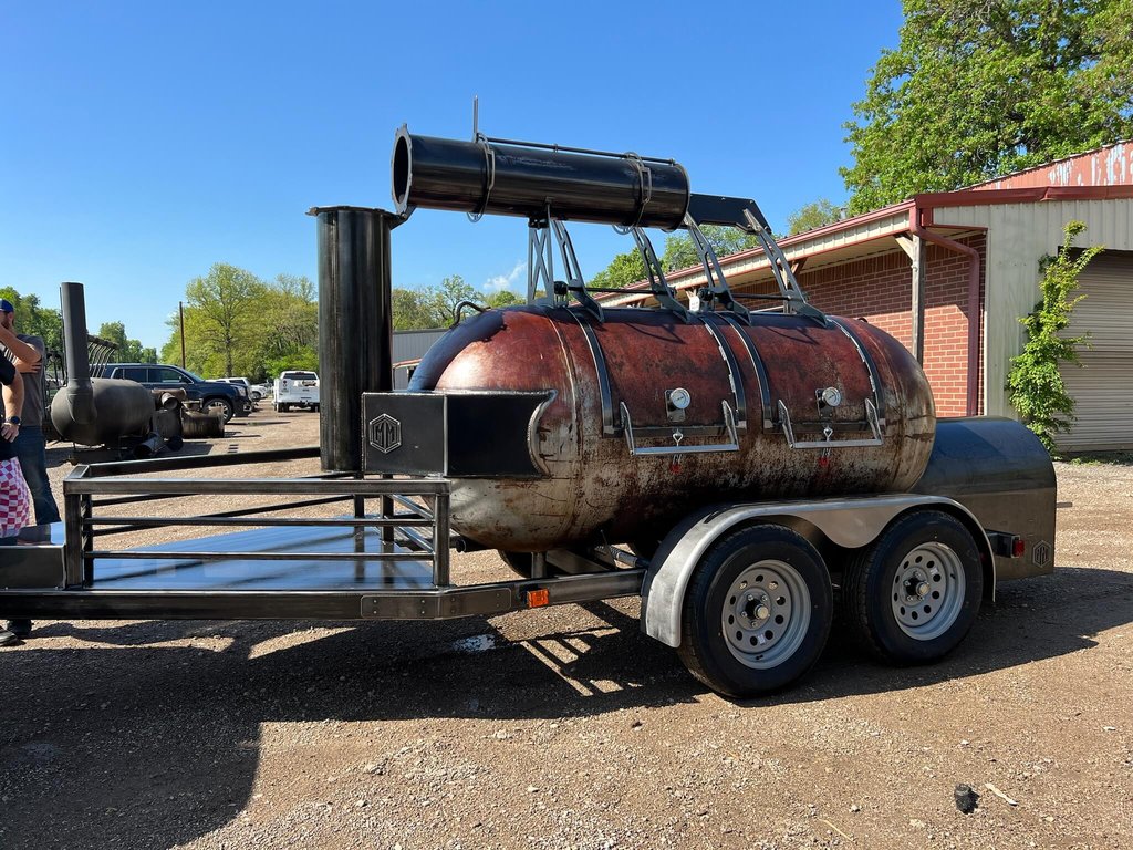 OS500 offset smoker with a raw steel cook chamber on its trailer