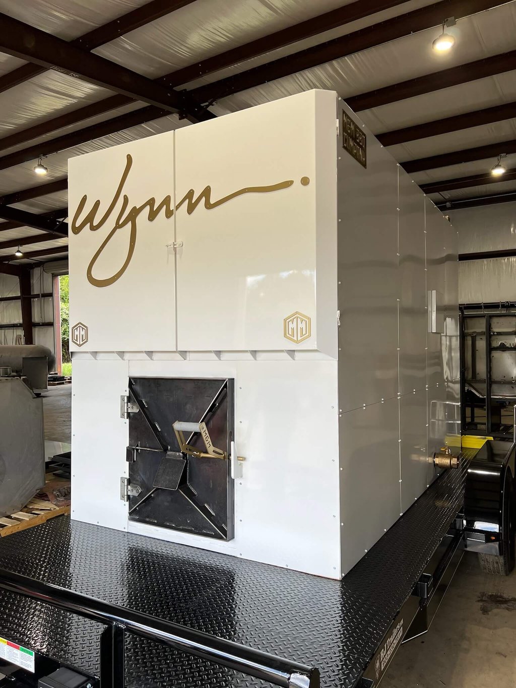 White custom rotisserie smoker with gold Wynn branding
