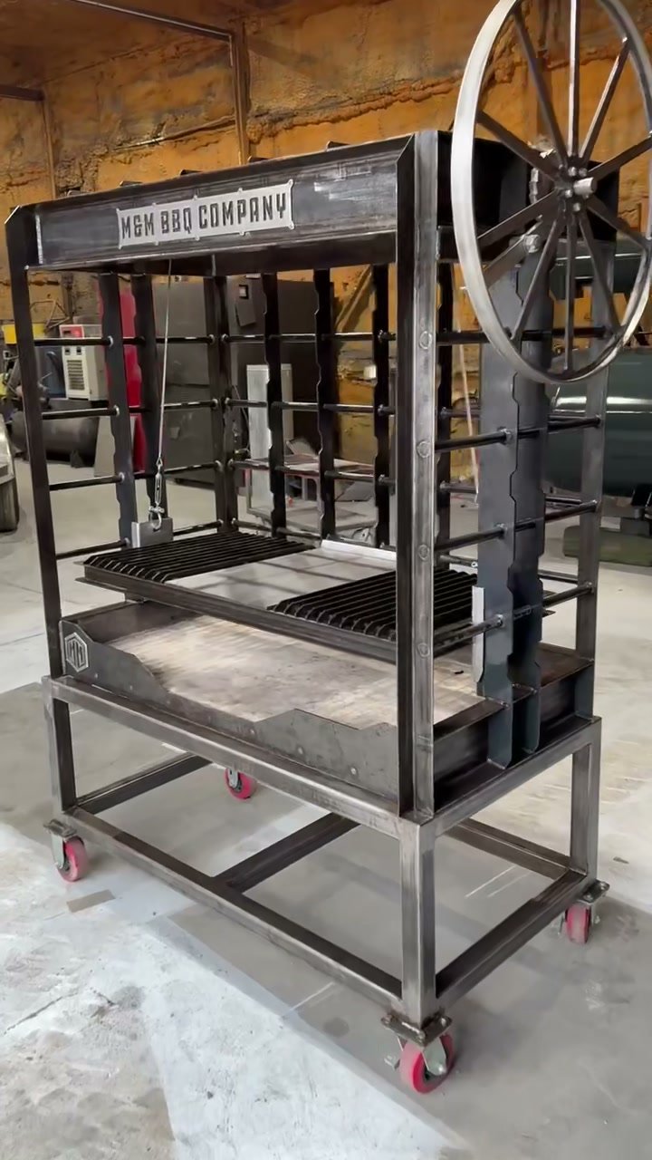 Vulcan live fire table in raw steel with its Santa Maria wheel and grate, angled view